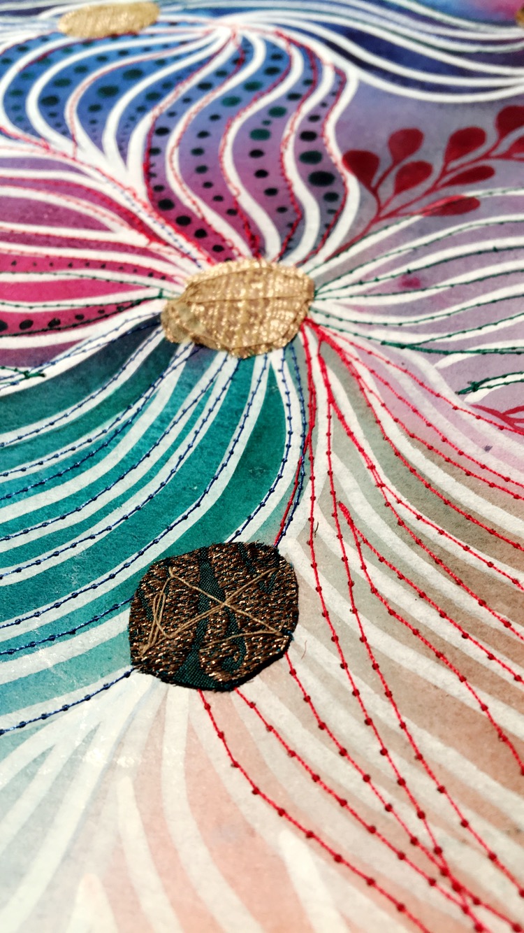 Stitched thread and fabric on watercolour