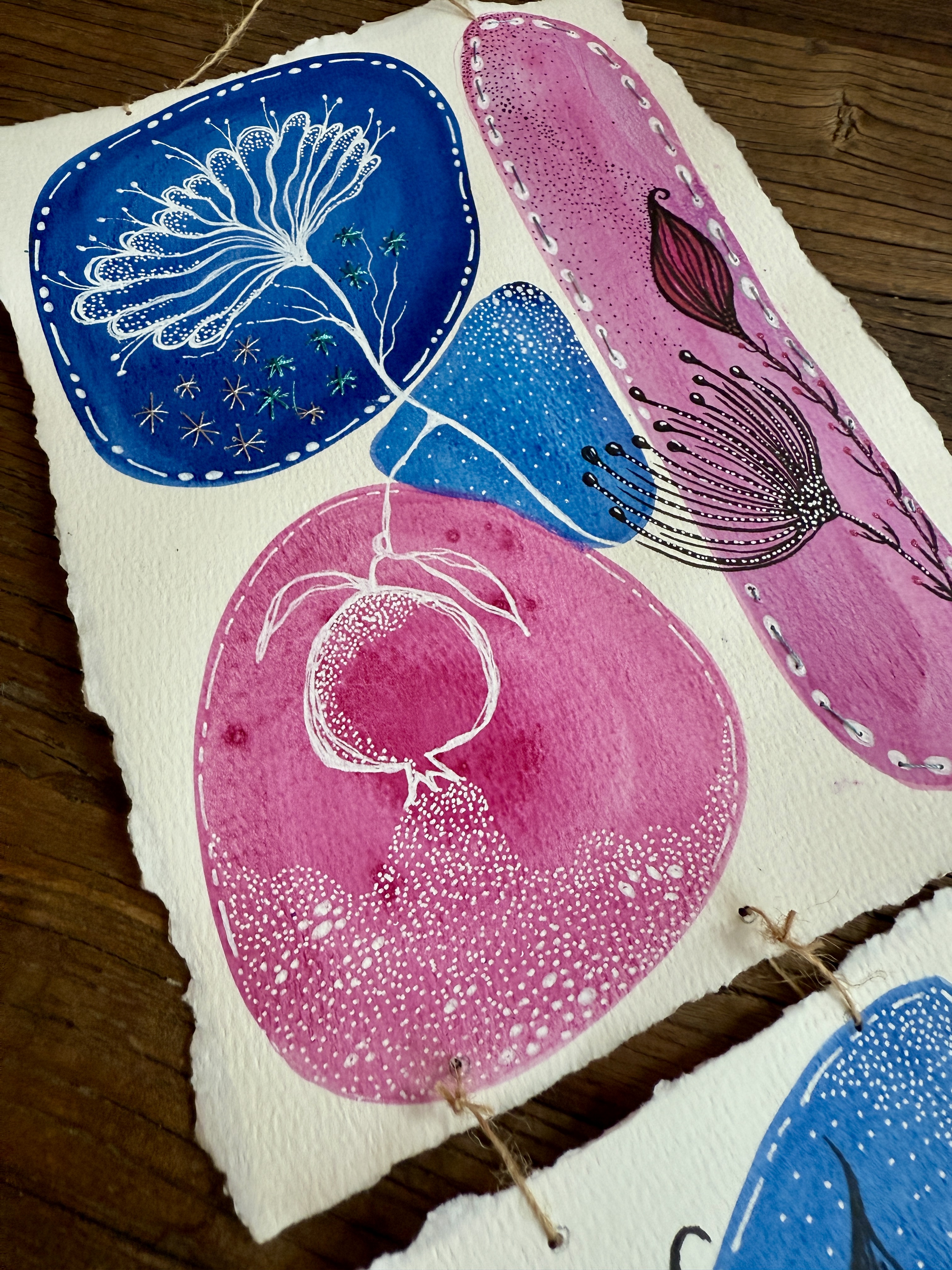 Stitched deckle-edge watercolor panels in blue and pink