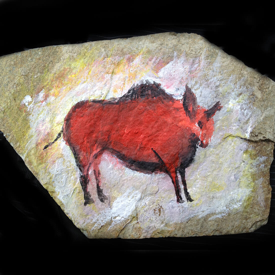 Red bison painted on raw stone